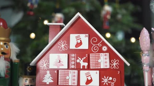 Wooden Tree Advent Calendar in Front of a Real Christmas Tree Decorated Nutcracker Soldier Toys.