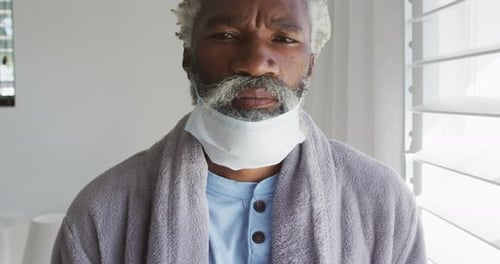 Senior Man with Mask Hanging From Neck