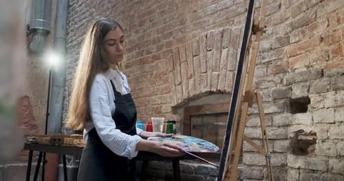 Talented Innovative Pretty Female Artist Draws with Brush on the Canvas. Contemporary Young Woman