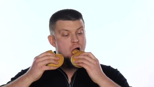 Man Enjoys Eating Two Burgers on White Background