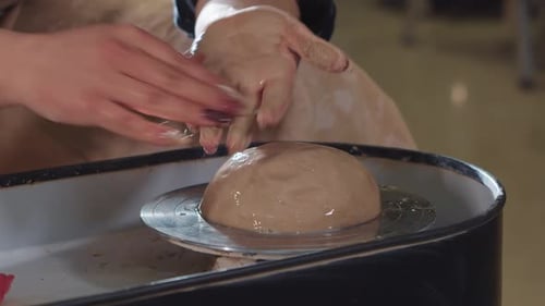 Artist Shaping Clay on Pottery Wheel