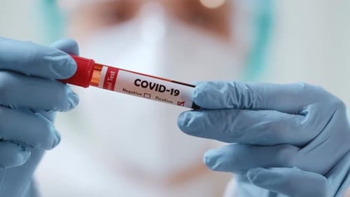 Healthcare Worker Holding Positive COVID-19 Blood Test