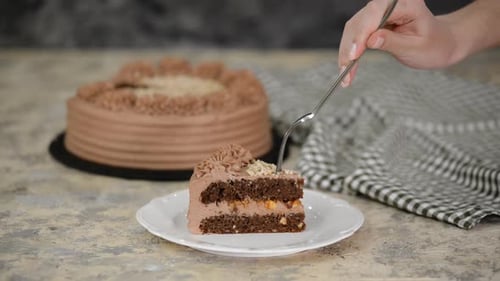 Fork Taking Bite from Chocolate Cake Slice