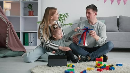 Family Giving Gift to Child on Birthday