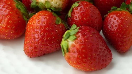 Juicy Red Strawberries on White Surface
