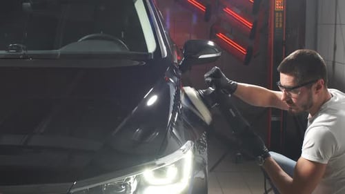 Master Polishes the Car in a Car Workshop.