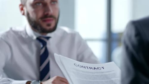 Businessman Signing Contract with Partner