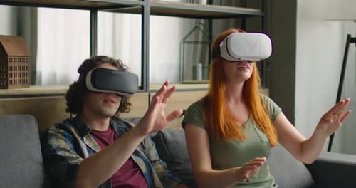 Couple Using Virtual Reality Headsets at Home