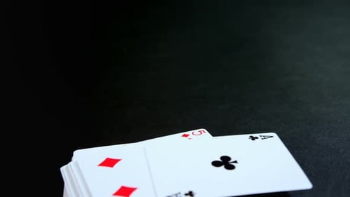 Playing Cards Falling onto Black Surface