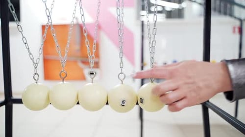 Newton's cradle showing laws of physics in motion. Museum of Science and newton pendulum