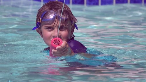 A boy plays in a pool at a hotel resort.