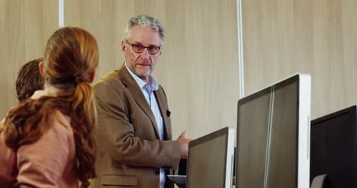 Adult Man Explaining Technology to Colleagues in Office