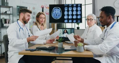 Doctors Meeting and Reviewing Medical Data