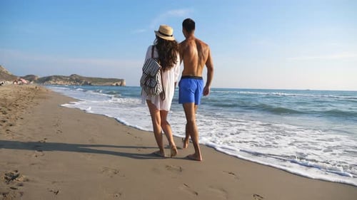 Couple of Lovers Walking at Coast and Holding Hands During Resting on Resort. Man Hugs Woman