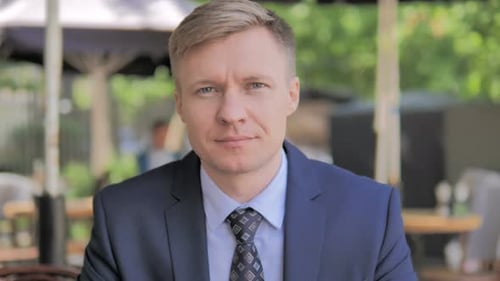 Adult Man in a Suit Looks Intently