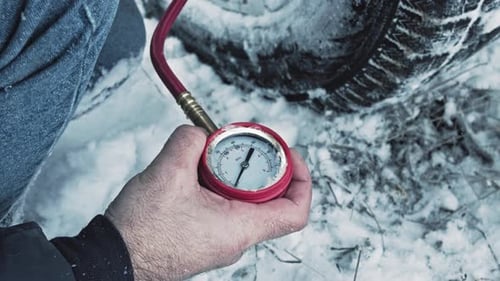 Tire Pressure Check in Winter Snow