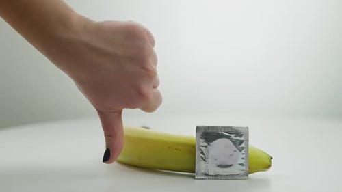 Thumb Down on Condom and Banana Concept