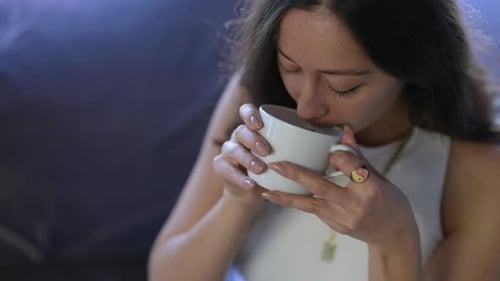 Beautiful Young Girl Drinks Coffee