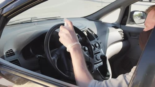 Man Cleans Car Interior Wearing Mask and Gloves