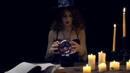 Woman Foretelling Future with Crystal Ball and Candles