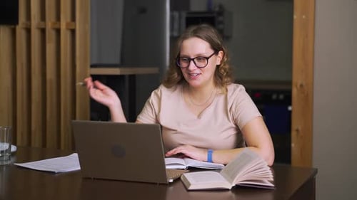 Woman Uses Laptop for Online Learning at Home