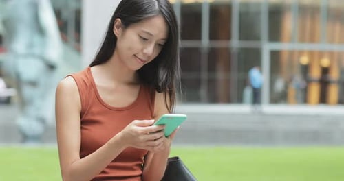 Woman use of mobile phone at outdoor street