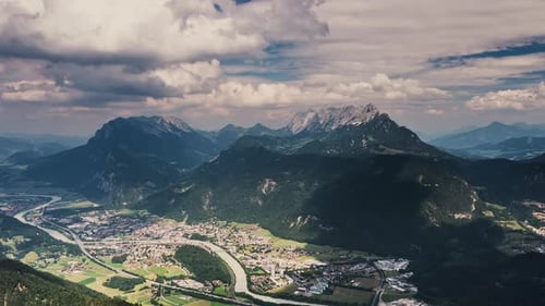 Timelapse scenery with mountain peaks and cloudy sky.