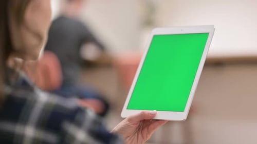 Female Using Tablet with Green Chroma Key Screen