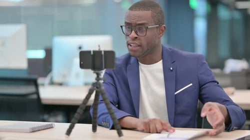Professional Man Delivering Presentation to Mobile Phone