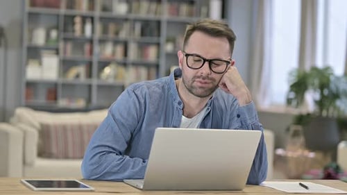 Sleepy Young Man Having Nap in Loft Office