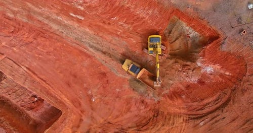 Excavator Loads Dump Truck at Construction Site