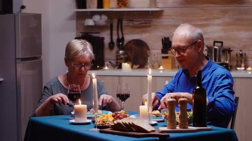 Senior Couple Enjoying Romantic Candlelit Dinner at Home