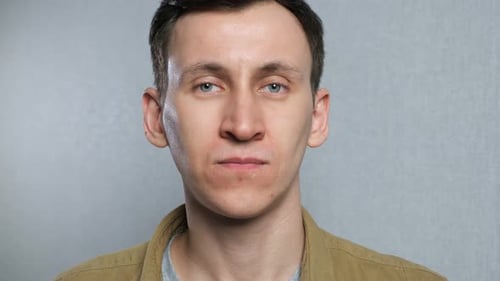 Young Man Taking Pill and Drinking Water