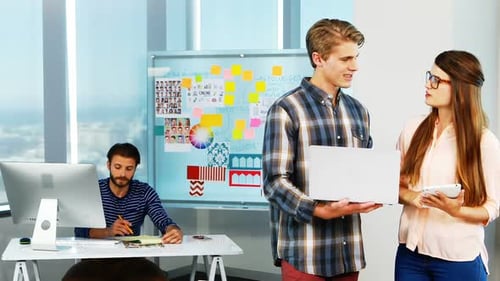Office Colleagues Discuss Business Project Together