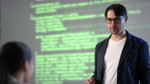 Female IT Student Raising Hand For Question