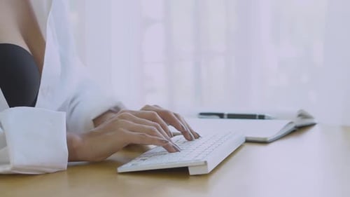 Woman Typing on Keyboard with Open Shirt