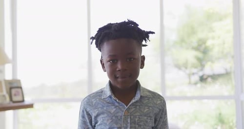 Young boy smiling at home