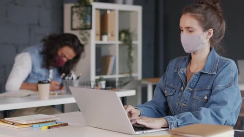 Young Businesswoman in Face Mask Working in Office