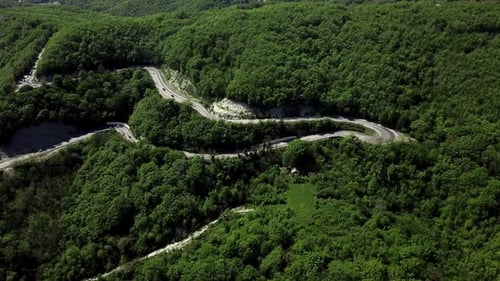 Drone View of a Curved Winding Road Trough the Mountains