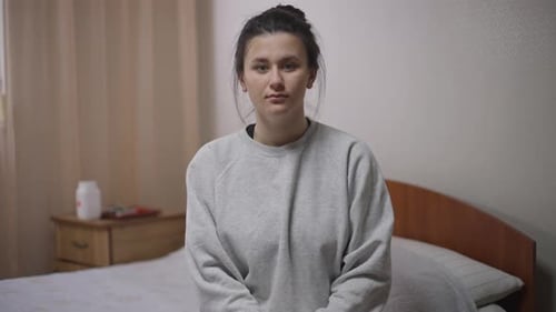 Woman Gives Thumbs Up and Smiles Indoors