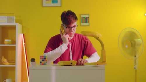 Young Adult Talking on Retro Landline Telephone