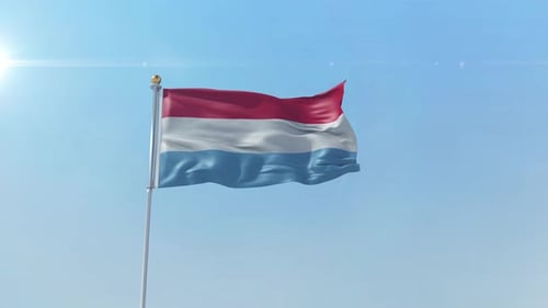 Realistic Waving Flag of Luxembourg Against Blue Sky
