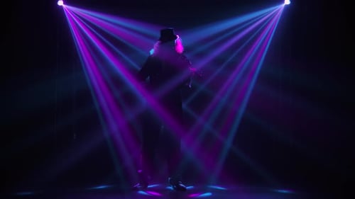 Violin Player Performing in Colorful Spotlights
