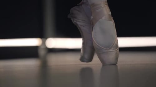 Close-up of Ballerina's Feet in Pointes Balancing on Tiptoes. Professional Female Ballet Dancer