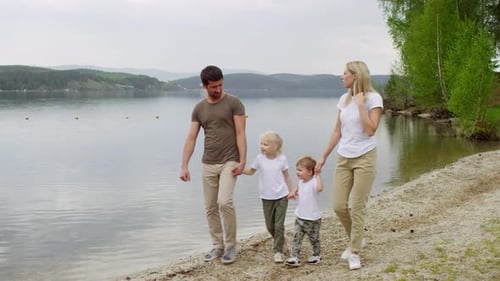 Family Walking by the Lake and Enjoying Scenery