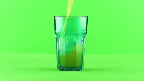 Juice Pouring Into Green Faceted Glass Isolated on Light Green Background Slow Motion
