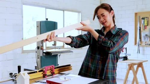 Architect student try to design construction for built-in furniture project in workshop