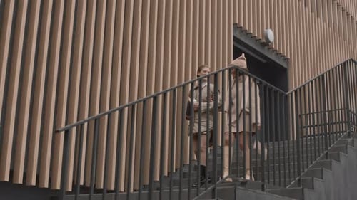 Two Girlfriends Going Down Stairs During Walk Outdoors