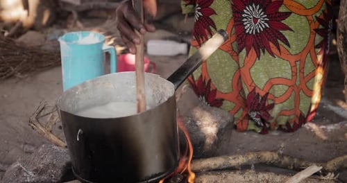 African mother cooking - 4K