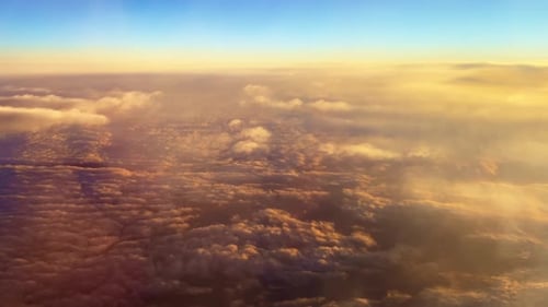 Aerial View of Golden Clouds at Sunset